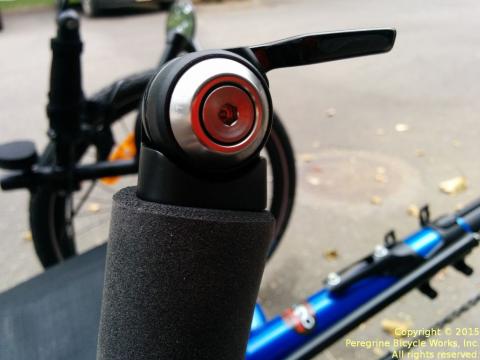 The thick closed-cell silicone grip holds the cable housing close to the handlebar where the barend shifter is installed on this recumbent trike.